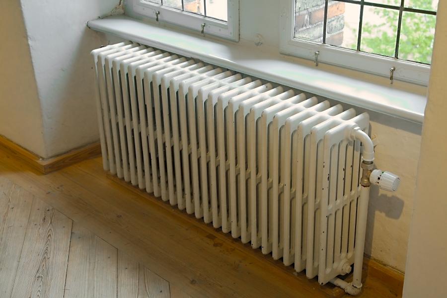 Photo of a steam heat radiator next to a window