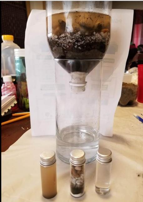 A homemade water filter crafted by Dario Jr. for his science fair project