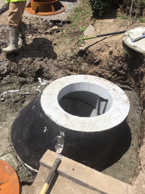 Crews make repairs to a manhole on Keefe Street