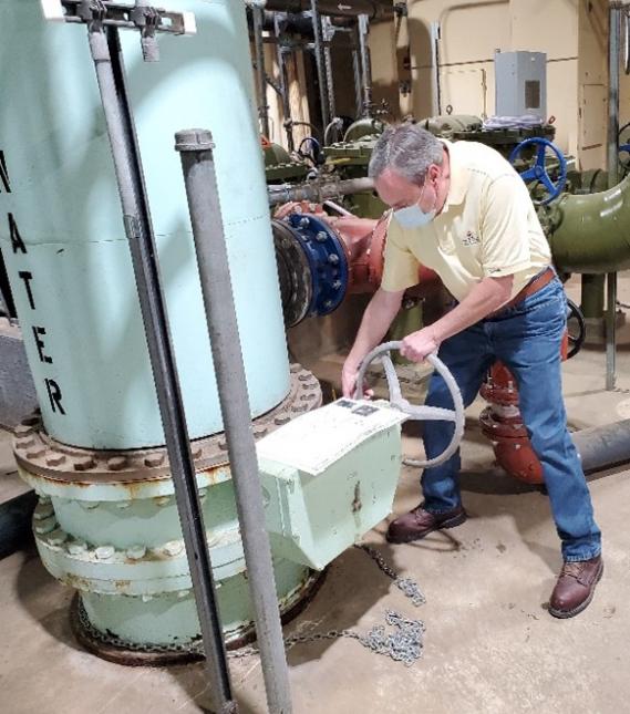 Dennis Graham, a consulting engineer with PWSA, opens the valve at the Microfiltration Plant.