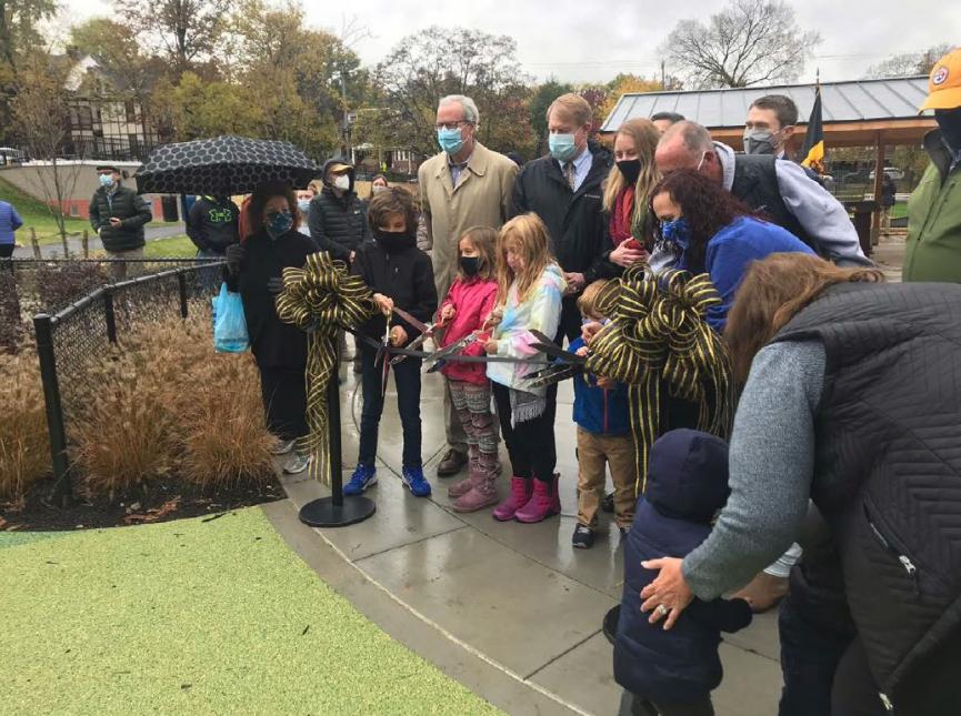 Community members and project partners participate in the ribbon cutting ceremony at Wightman Park.  