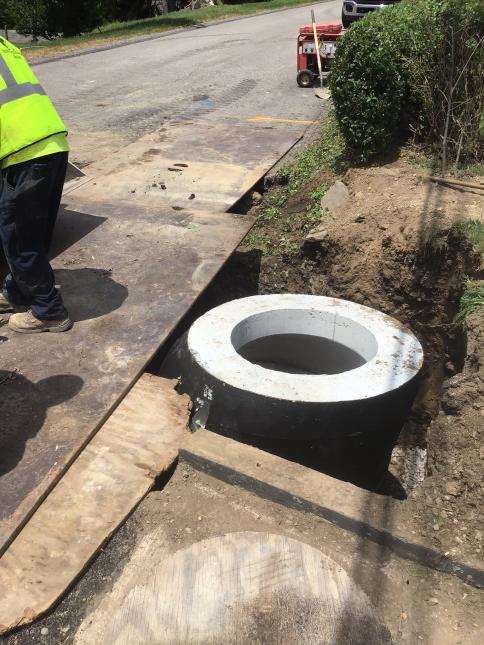 Crews install new sewer manhole on Keefe Street