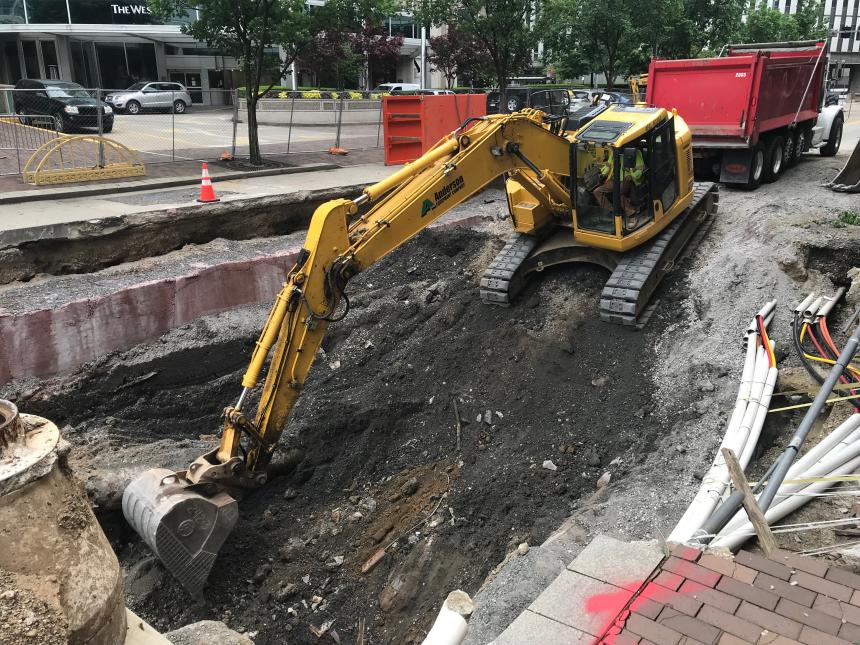 Machinery shoveling debris from the 10th Street sinkhole site