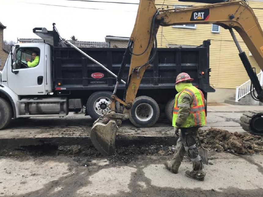A PWSA contractor replaces a water main in a Pittsburgh neighborhood.