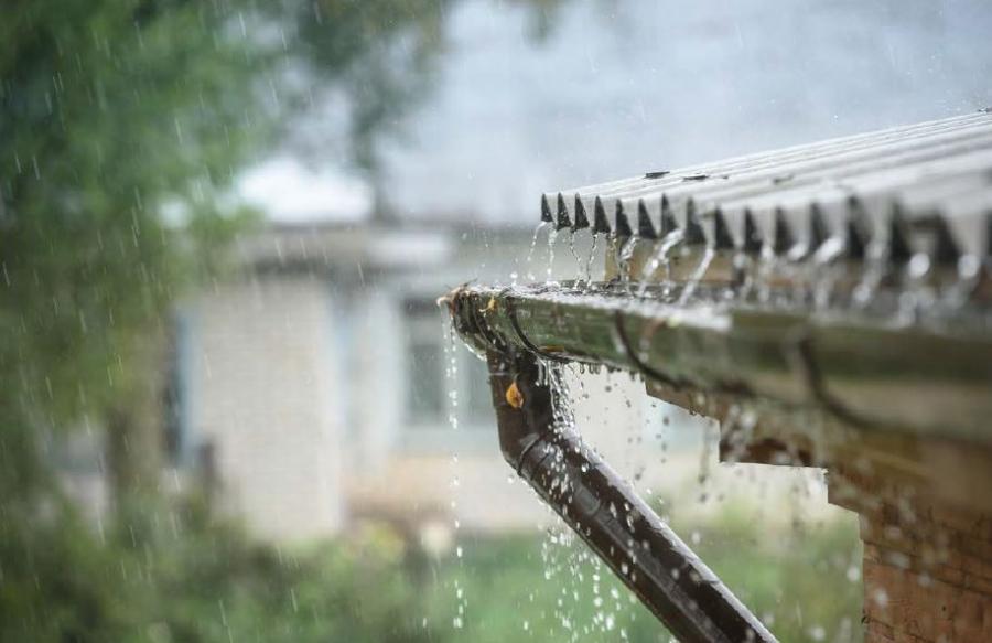 A home gutter taking on a lot of rain