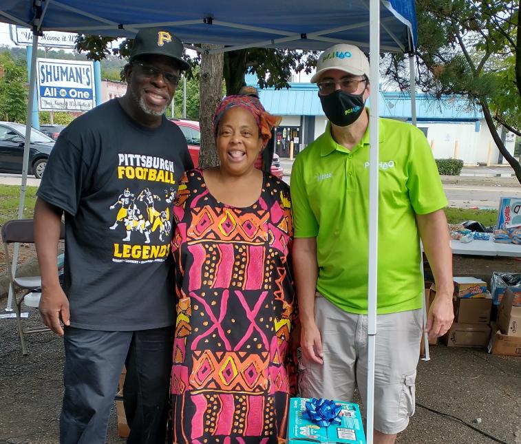 PGH2O Cares team member with winners of gift basket at community event.