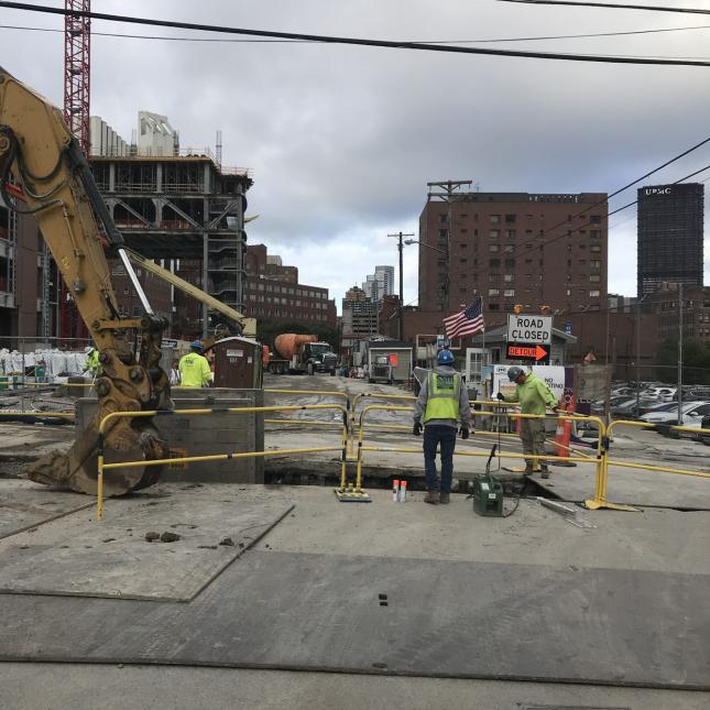 Crews work to relocate an existing sewer line near UPMC Mercy.