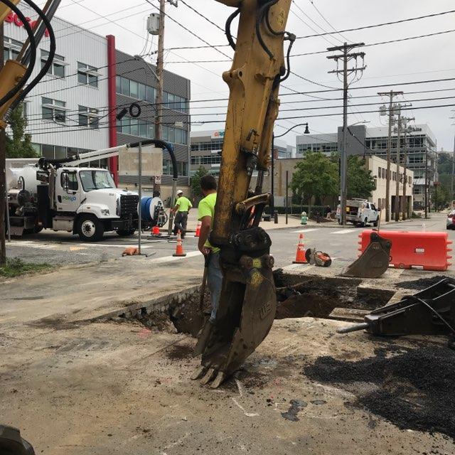PWSA crews uncover a water main in the Strip District.