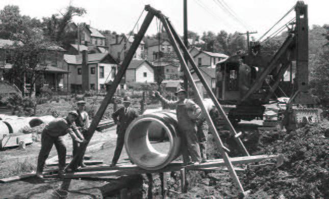 Old fashioned photograph of workers installing a sewer
