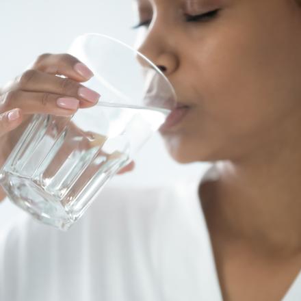 Stock photo of woman drinking a clean glass of water