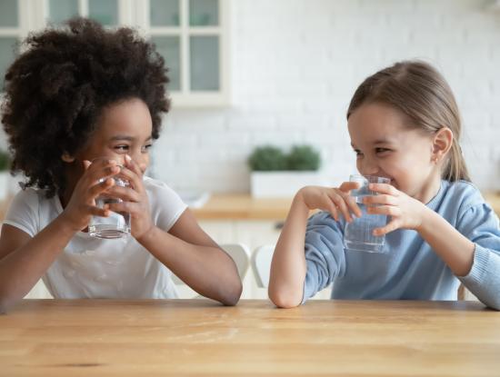 Stock photo girls laughing drinking water