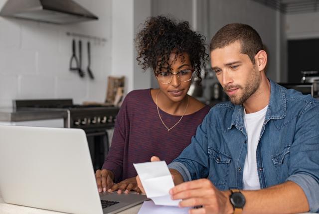 Stock photo of couple reviewing bills