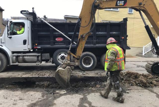 Construction crews prepare trench for water main replacement in Homewood