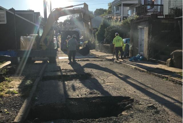 Crews install new service lines during a water main replacement in South Side Slopes.
