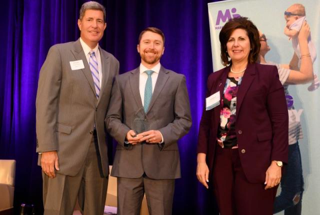 CEO Will Pikering accepting award with March of Dimes representatives.
